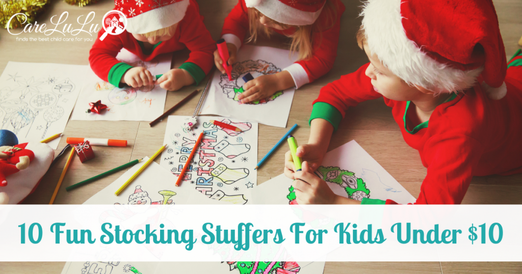 Happy toddlers and preschoolers drawing and coloring during Christmas time.